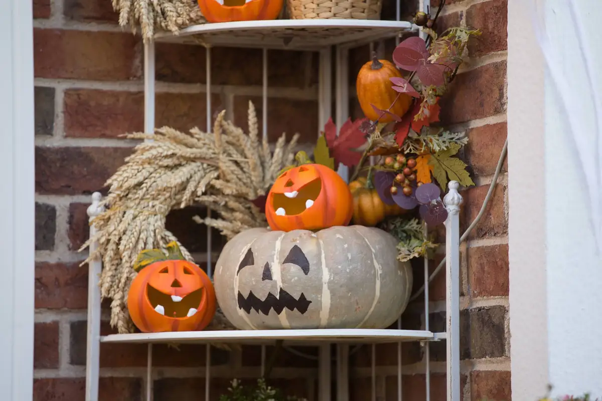 Jack-o-lanterns decorating a front porch for Halloween